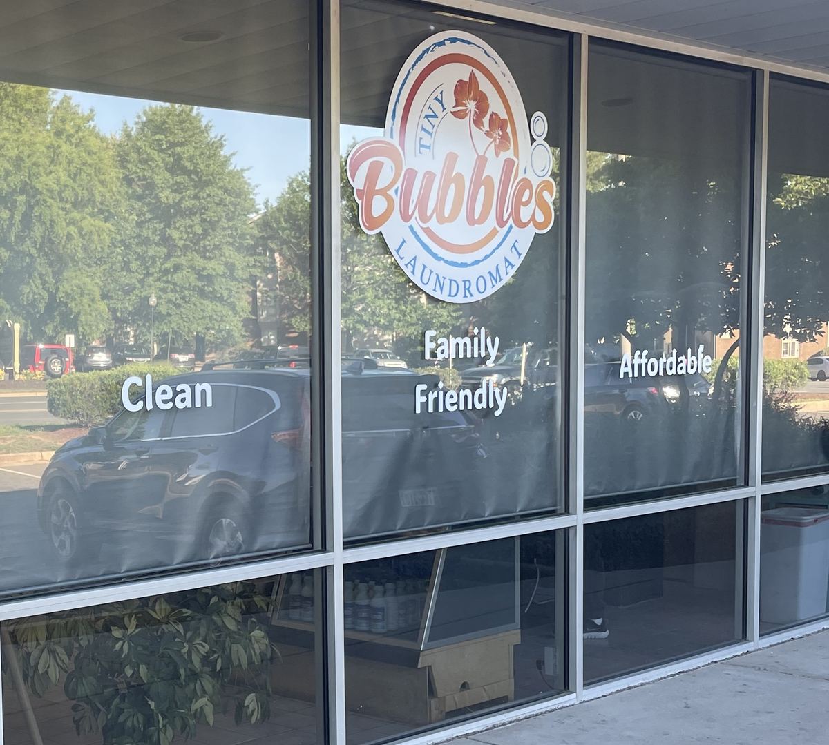 The Tiny Bubbles storefront in Manassas, with Clean, Family Friendly and Affordable on the glass